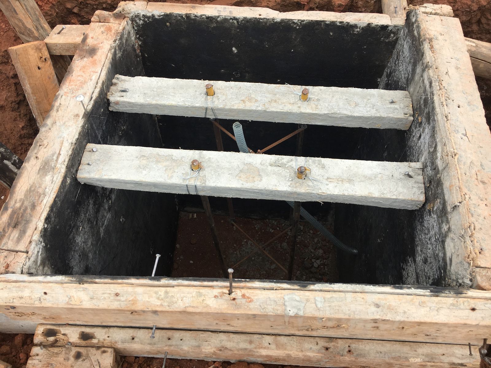 Foundation pit with formwork, anchor bolts and cable conduit